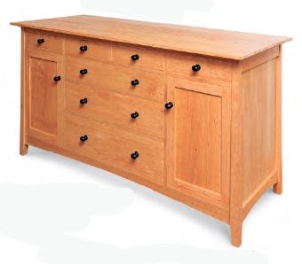 Front view of completed cherry sideboard with brass hardware