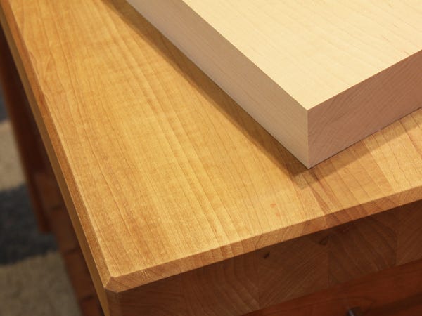A maple countertop with stain applied and an unfinished piece