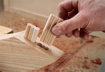 Inserting dowels into joint cut with beadlock jig