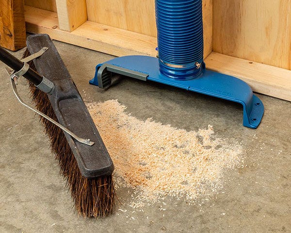sweeping floor sawdust into floor sweep dust chute