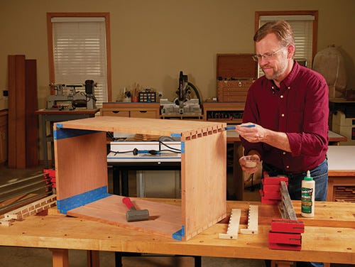 Applying glue to dovetail joint and clamping the finished joinery