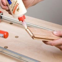 Applying glue to interior groove of panel frame