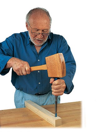 Ian Kirby chopping out a mortise with a chisel and hammer