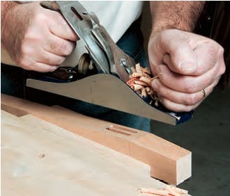 Smoothing sideboard legs with a hand plane