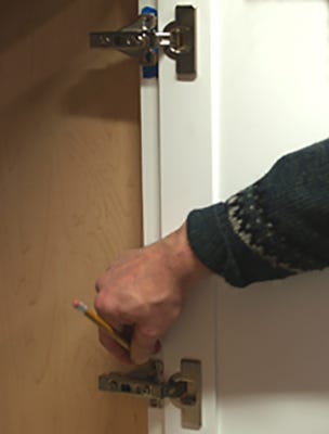 Test fitting door on cabinet frame