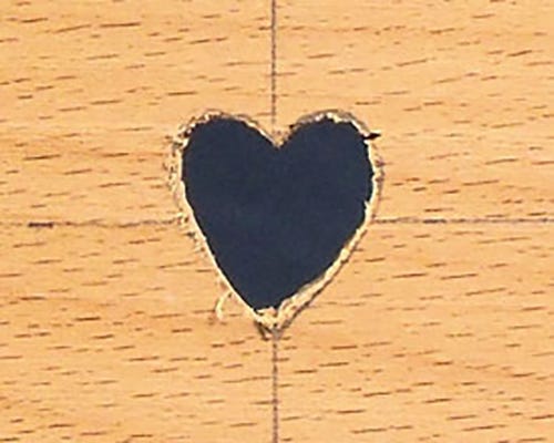 Heart shaped hole carved out with coping saw