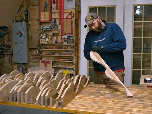 Paul Jackman installing a series of ash wood accent shelves