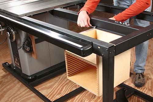 Installing saw blade storage cabinet under extension table