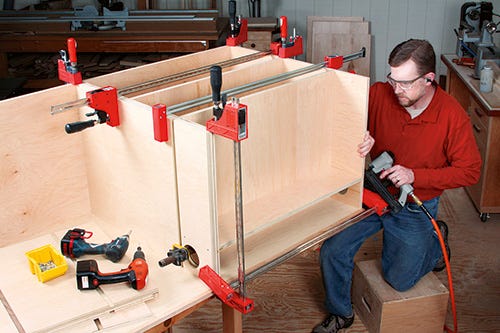 Using brad nails to assemble cabinet base and shelving