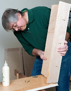 Attaching cabinet bottom assembly with biscuits