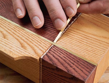 Gluing brass bars into place