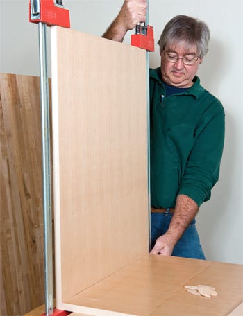 Clamping kitchen cabinet side panel in place