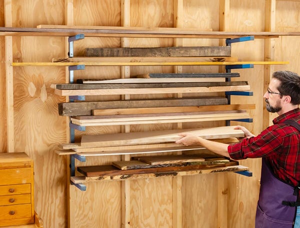 man loading lumber on a rack