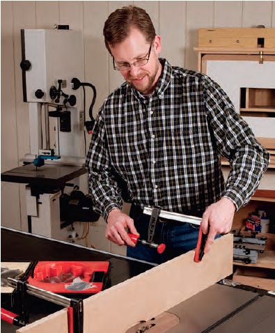 man using wood clamps