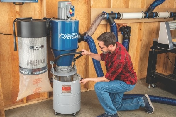 man setting up dust right cyclone dust collector