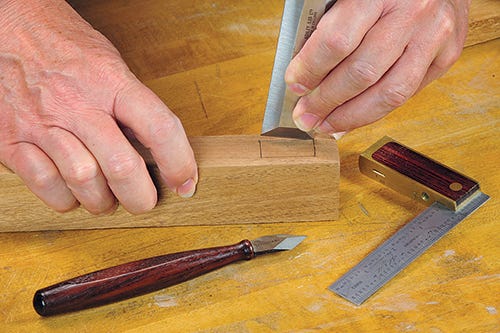 Using a marking knife and chisel to mark a cut
