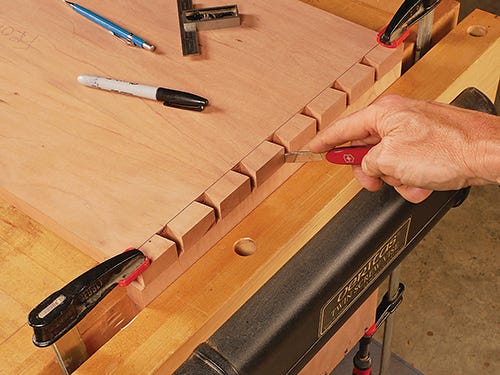 Marking knife cuts laying out tailboard pattern for dovetail joint