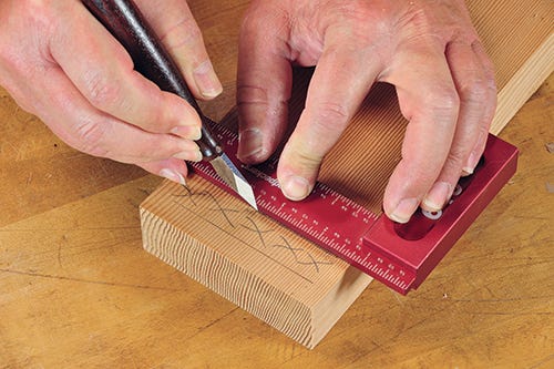 Using a marking knife to indicate a joinery cut