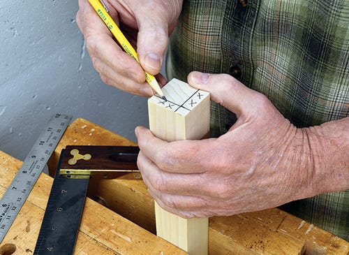 Drawing layout lines on end of leg blank to guide taper cuts