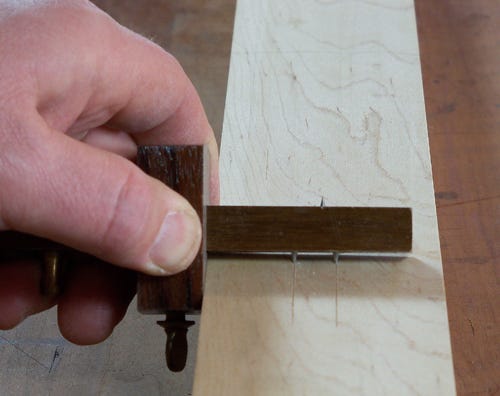 Using marking gauge to lay out mortise cuts
