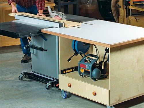 Table saw outfeed table with storage, air compressor and electrical outlet