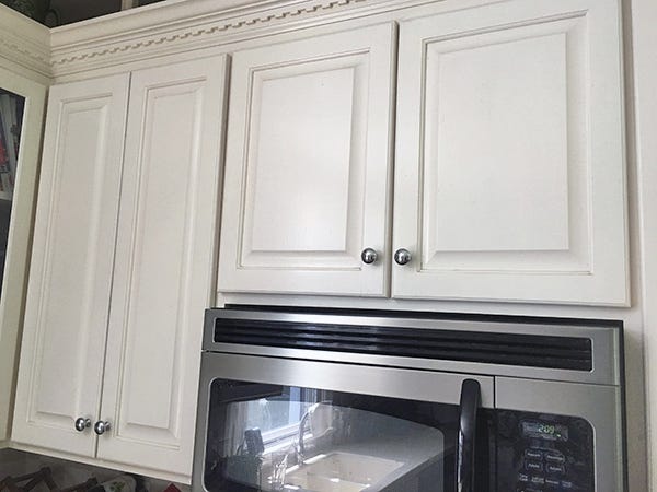 White painted above counter kitchen cabinets