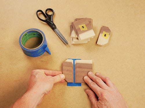 painters tape used as hinge on piece of wood