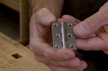 Demonstrating the use of a butt hinge