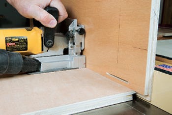 Using plywood panel to support joiner while cutting