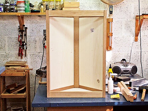 Gluing panels in place for corner cabinet