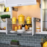 Swing down storage rack for upper cabinets