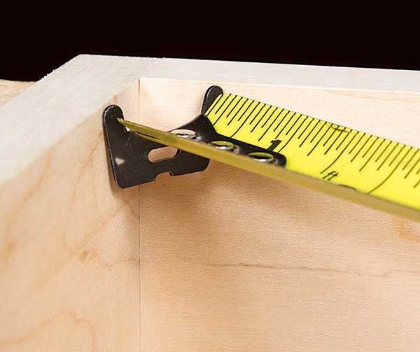 Checking box corner with a tape measure