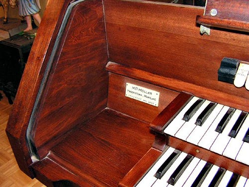 An organ finished with oil-based red mahogany stain