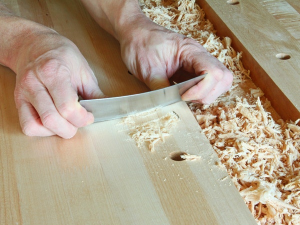 Scraping down the top of a softwood workbench