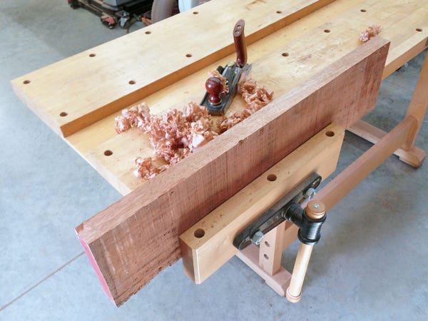 Workbench vise mounted to the right side of a table