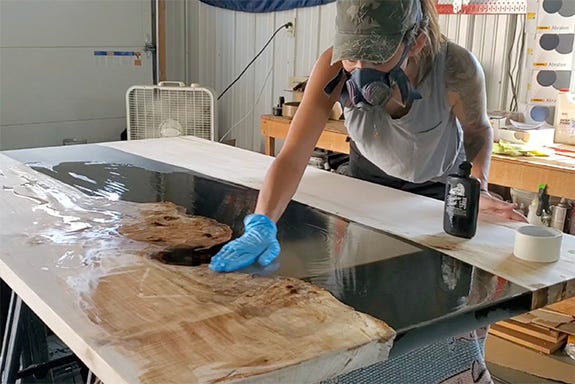 applying finish to river table