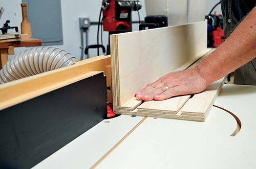 Trimming edges of back of shelving with roundover bit