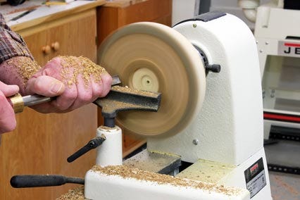 Turning the interior of a natural edge bowl with a lathe and gouge