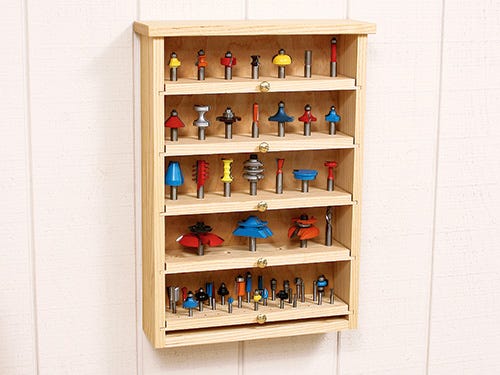 Router bit cabinet with pull-out storage shelves