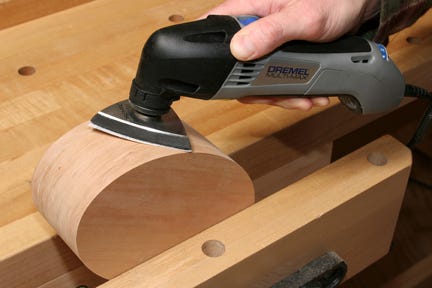 Sanding edges of box lid with a detail sander