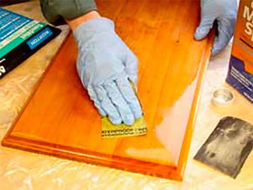 Wet sanding a panel with sandpaper and mineral spirits