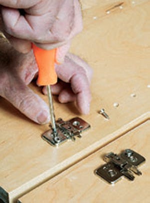 Attaching european hinge plate to cabinet side panel