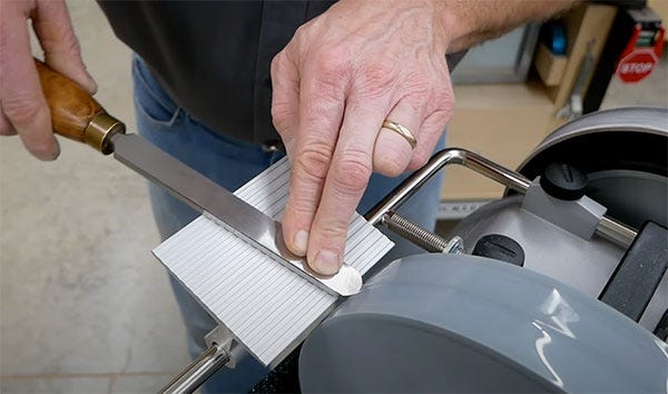sharpening a turning scraper with a wet stone grinder