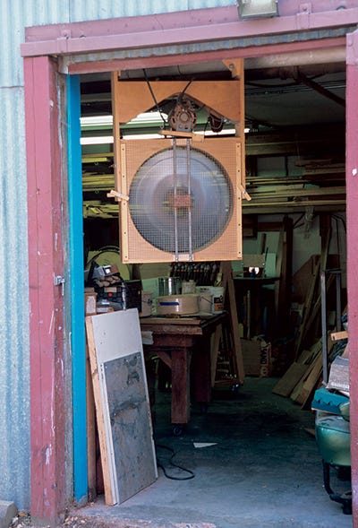 Industrial fan installed in workshop doorway