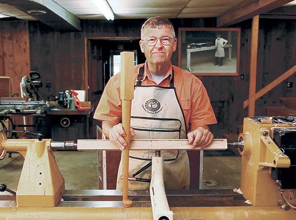 Ernie Conover demonstrating a freshly turned cabriole leg