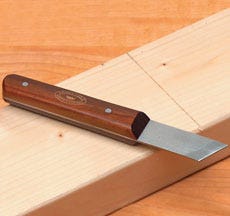 Marking knife with a wood handle and a single beveled edge