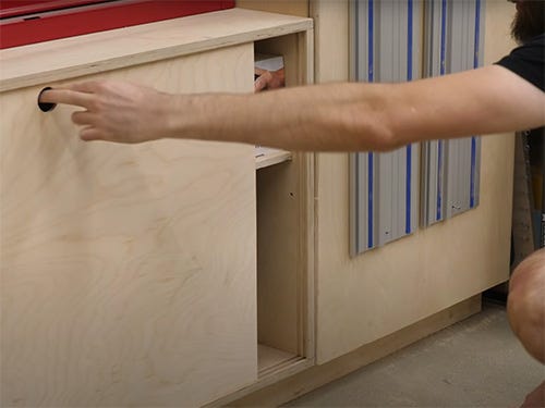 Chris Salomone testing a sliding cabinet door