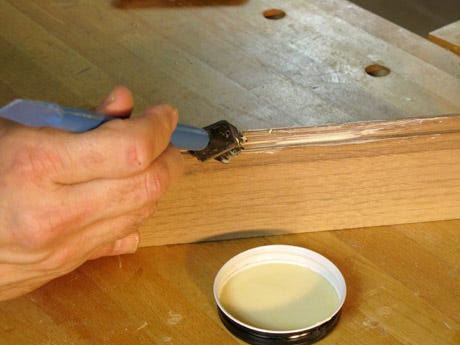 Using a silicon glue brush to apply glue on a lap joint