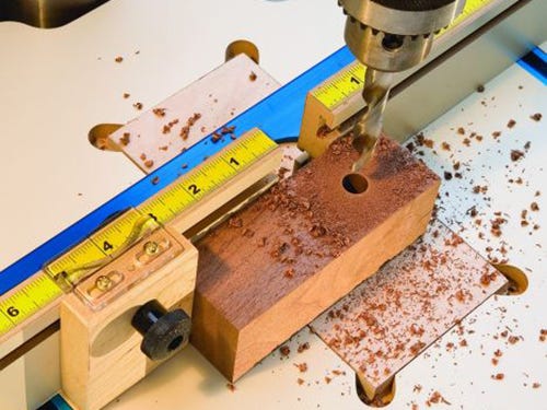 Drilling jig with attached measuring tape