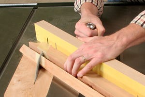 Cutting through a table saw jig with sandpaper adhered to it